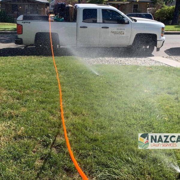 Nazca Services branded truck with sprinkler system in Denver